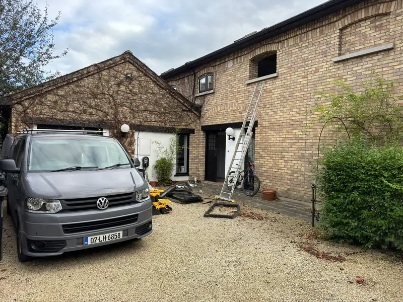 Edal Construction van and ladder set up at a brick house for a roof repair callout